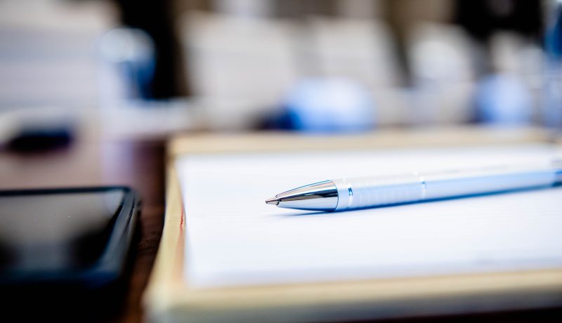 Note pad and pen on a desk